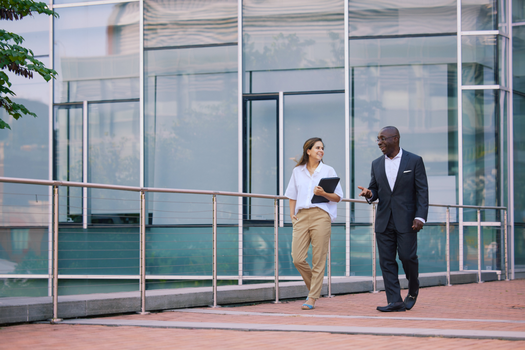 professor and MBA student walking outside Hariri